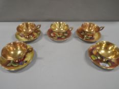 Five Coalport orchard gold cups and saucers with gilded interiors