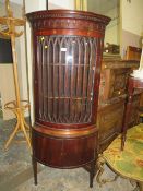 A reproduction mahogany glazed bow fronted corner cabinet
