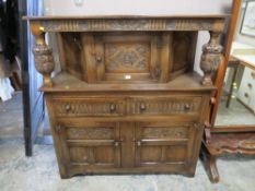 An oak carved court cupboard made for Rackhams