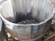 A very large half barrel oak garden planter
