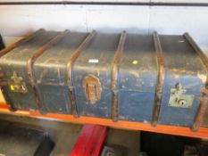 A vintage steamer travel trunk with 6 wooden ribs
