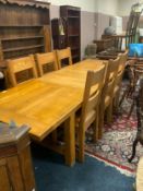 A modern heavy oak extending dining table and six chairs
