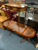A reproduction mahogany oval coffee table with leather top together with a smaller mahogany