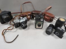 A tray of vintage cameras and lenses