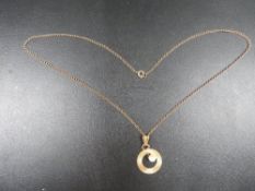 A hallmarked 9 carat gold pendant set with a seed pearl approx. weight 2.8g