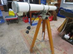 A vintage astronomical telescope on tripod stand