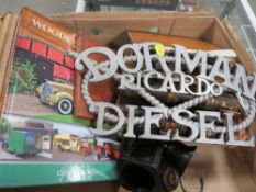 A tray of assorted collectables to include an aluminium Dorman Diesel sign, vintage books etc