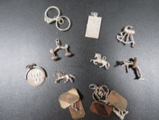 Nine vintage silver bracelet charms and a pair of 9ct gold on silver cufflinks