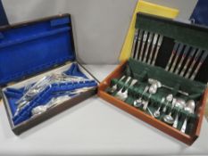 A cutlery canteen and contents (unchecked) together with another