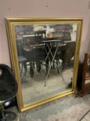 A large modern gilt framed rectangular wall mirror 130 x 106 cm