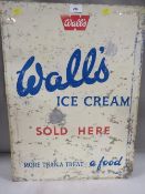 A vintage painted metal advertising sign for Walls ice cream