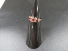 A 9ct gold ring set with rubies and small diamonds approx. 1.4g