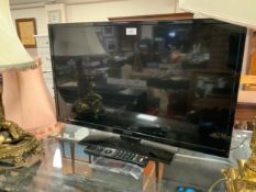 A Hitachi 31“ flatscreen television with remote - House Clearance
