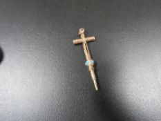 An unusual yellow metal cross pendant with integral slide action pencil , the slider being set