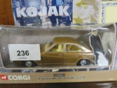 A Japanese tin plate friction drive model car in original box together with a boxed Corgi Kojak
