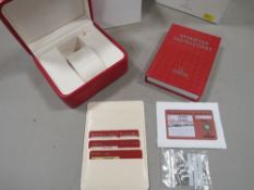 An Omega box and contents to include spare links