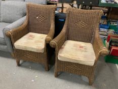 A pair of wicker armchairs