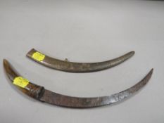 A vintage Asian dagger with brass sheath and horn handle