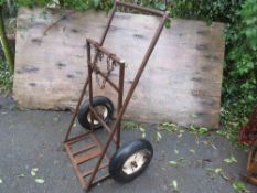 A vintage welding gas bottle trolley