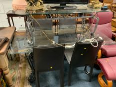 A modern glass topped dining table with four chairs together with a similar coffee table