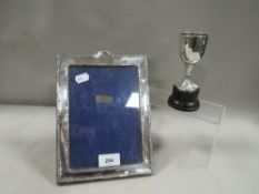 A silver hallmarked photo frame and trophy