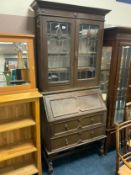 A vintage oak bureau bookcase
