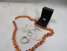 A 9ct gold ring, two silver rings, silver chains plus an amber necklace