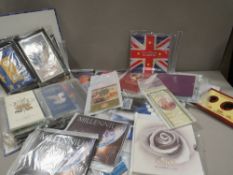 A collection of Royal Mint uncirculated packs, to include 50 pence, two pound and five pound coin