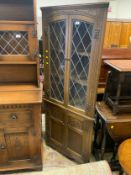 A reproduction oak leaded corner cabinet
