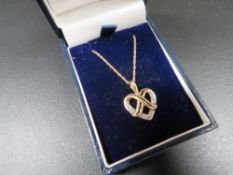 A hallmarked 9ct gold & diamond set heart necklace