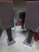 A pair of Festival 3 speakers and stands together with a mirrored bathroom cabinet