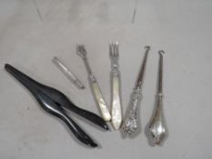 A small bag of silver and other collectables to include a pair of ebonised glove stretchers, a