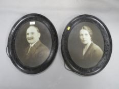 A pair of oval oak framed photographs