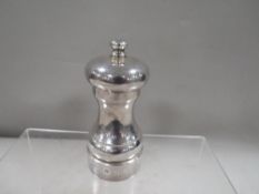 A hallmarked silver pepper grinder