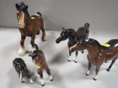 A collection of five Beswick horses to include a cantering shire