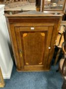 A Georgian oak and mahogany hanging corner cupboard