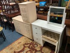 A modern dressing table with mirror and stool together with two modern chest of drawers