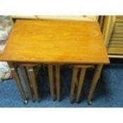 A retro teak nest of three tables
