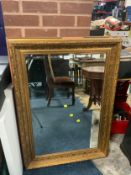 A modern heavy gilt framed rectangular wall mirror 110 x 79 cm