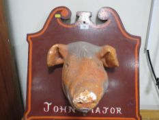 A vintage plaster study of a pigs head on a wooden plaque titles 'John Major', inscribed verso '