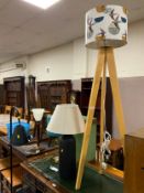 A modern floor standing standard lamp together with two table lamps and another floor standing