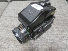 A vintage Mamiya 645 camera 1000s together with a Mamiya M645 prism finder