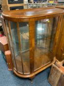 A vintage walnut china cabinet