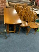 A modern dropleaf table with six wheel back chairs