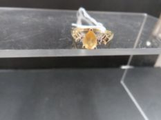 A hallmarked 9ct gold dress ring set with small diamonds and citrine stone, size L