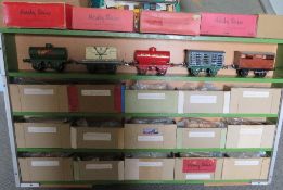 A WOODEN CABINET CONTAINING TWENTY PIECES OF O GAUGE ROLLING STOCK, to include tankers, cattle