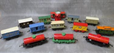 THIRTEEN UNBOXED PIECES OF O GAUGE ROLLING STOCK, comprising three tankers and ten covered wagons
