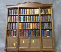 A MINIATURE WOODEN BOOKCASE CONTAINING SEVENTY FOUR MINIATURE CLASSIC DEL PRADO LIBRARY HARDBACK