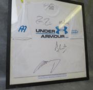 A FRAMED UNDER ARMOUR T-SHIRT, signed at a live exhibition tennis math by Roger Federer, Tim Henman,