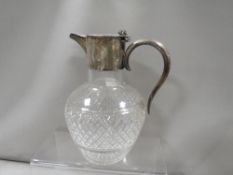 A hallmarked silver topped glass ewer engraved Sutton-On-Sea August 1897
